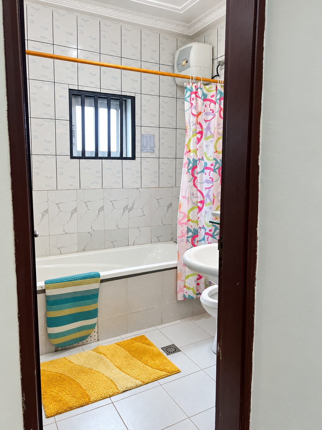Modern coastal bathroom with clean vanity and warm tile accents